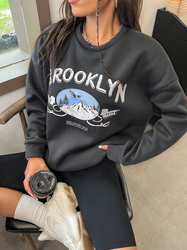 Áo nỉ Đồ họa đại bàng và chữ cái Thả vai - Màu xám đen - Xem 1