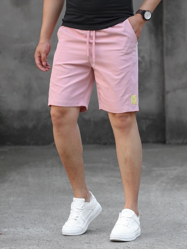 Manfinity Homme Pantalones cortos holgados para hombre con parche con letras, cordón, lisos y casuales hasta la rodilla, pantalones cortos con cordón de color rosa claro, para regalos de esposo o novio