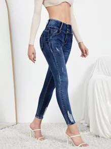 SHEIN Essnce Jeans ajustados rotos con diseño de botón