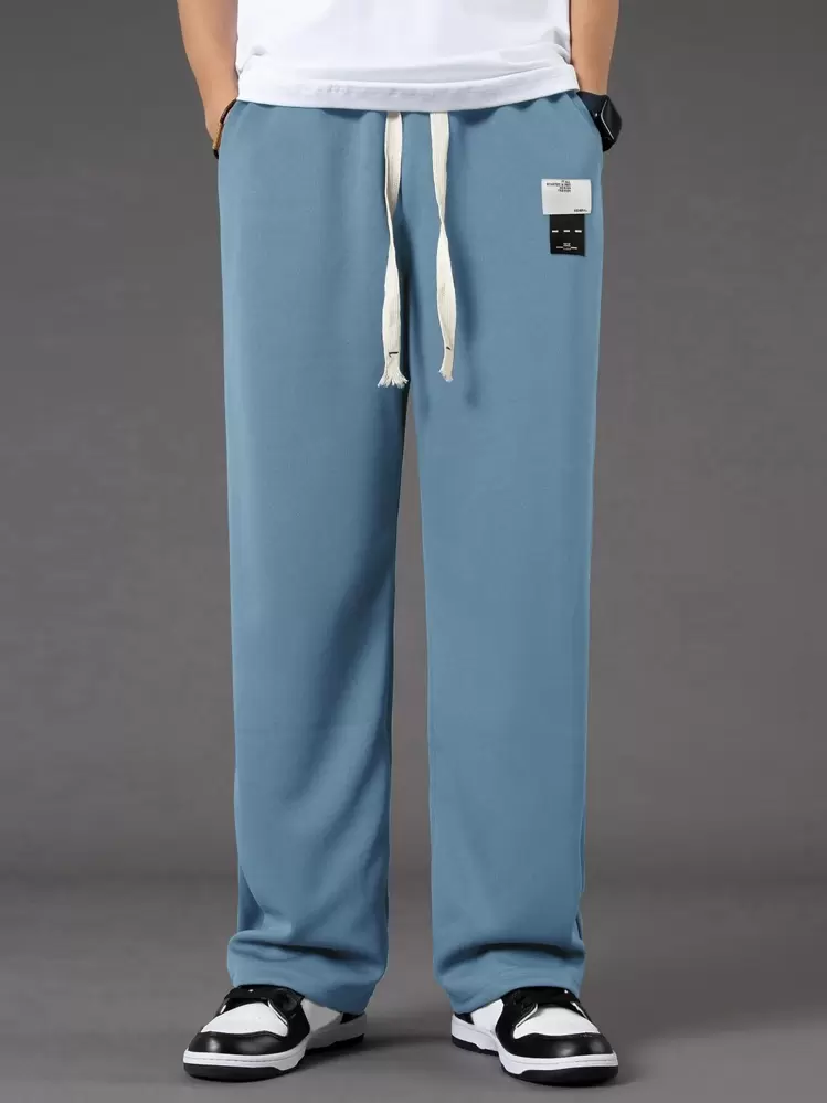 Manfinity Hypemode 細部に文字入りのジップアップスウェットパンツ ロングパンツ ストリートウェア - ダスティブルー - 見る 1