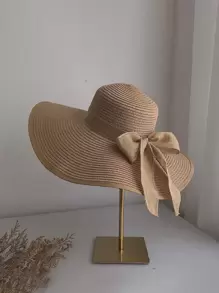 Un sombrero de sol para mujeres con lazo, borde plegable, protección UV y adecuado para playa o moños
