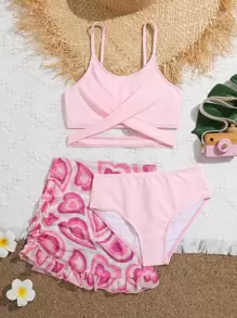 青少年女孩交叉比基尼套装，配有心形印花荷叶边下摆沙滩裙，夏季海滩