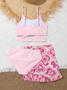 青少年女孩交叉比基尼套装，配有心形印花荷叶边下摆沙滩裙，夏季海滩