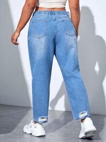 Jeans ajustados mom desgarro de talle alto