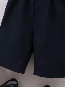 小男童前蝴蝶結襯衫和背帶短褲