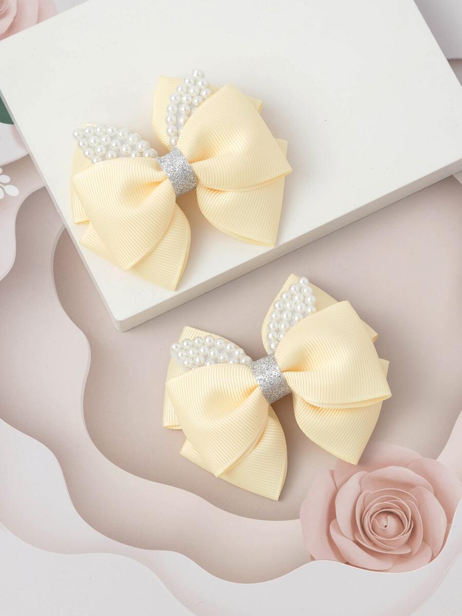2入組小女童人造珍珠和蝴蝶結裝飾時尚髮夾