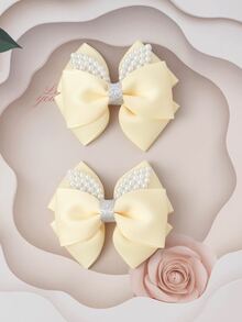2入組小女童人造珍珠和蝴蝶結裝飾時尚髮夾