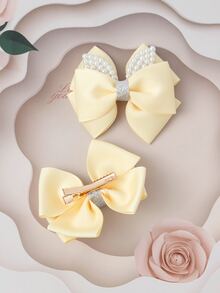 2入組小女童人造珍珠和蝴蝶結裝飾時尚髮夾
