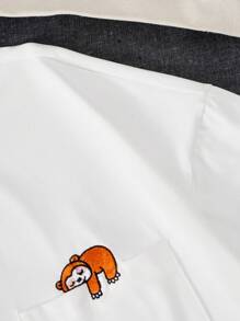 Manfinity Hypemode Camiseta holgada para hombre con bordado de dibujos animados y escote caído