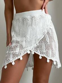 Gonna copri-costumi estiva con orlo avvolgente, decorata con pompon e fori