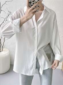 Camisa amplia de hombros caídos unicolor