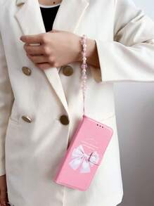 Peach Large Bow Faux Pearl Decor Wristband Case Compatible With IPhone 16, IPhone 16 Pro, IPhone 16 Plus, IPhone 16 Pro Max, Galaxy S25 Ultra, Galaxy S24 Ultra 5G
