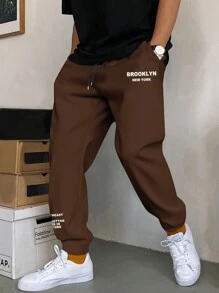 Manfinity Homme Lỏng lẻo phù hợp Nam Đồ họa Chữ cái Eo dây rút Quần thể thao - Cà phê nâu - Xem 1