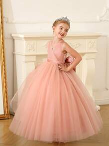 Robe rose pour fille pré-adolescente en maille ajourée avec décoration de nœud papillon et jupe bouffante