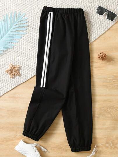 SHEIN Pantalones deportivos informales con dobles rayas blancas en los costados y piernas cónicas para niño preadolescente