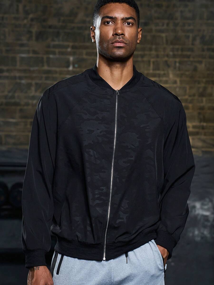 Manfinity Sport Corelite Chaqueta bomber con cremallera y estampado de camuflaje para hombres, chaqueta deportiva para entrenamiento - Negro - Ver 1