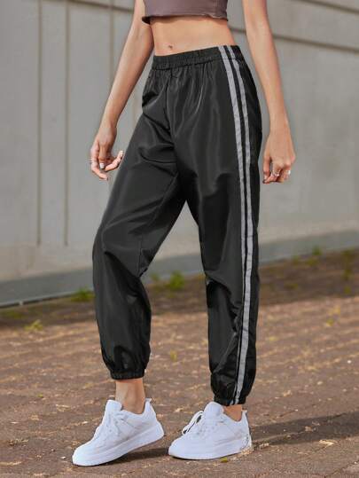 Pantalon de survêtement coupe-vent avec rayures réfléchissantes