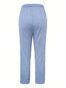 Pantalones de mujer de unicolor con detalles de botones y cintura con cordón