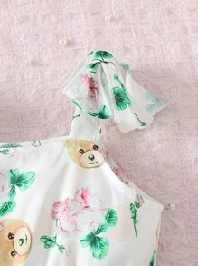 SHEIN Young Girls' Lovely Printed Bear And Flower Pattern Spaghetti Strap Dress With Bowknot And Pleated Detail, Suitable For Party, Vacation, Summer