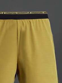 Manfinity Sport Corelite Herren Sport Shorts mit Buchstaben Muster und Kordelzug, Gelbe Jogger Shorts