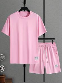 Manfinity Homme Conjunto de camiseta de manga corta y pantalones cortos con recorte de color bloque rosado para salir, para hombre