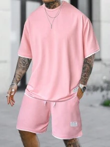 Manfinity Homme Conjunto de camiseta de manga corta y pantalones cortos con recorte de color bloque rosado para salir, para hombre