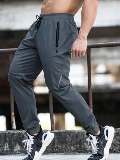 Manfinity Sport Corelite Boyfriend Style Men Drawstring Waist Zipper Pocket Sports Pants Fall Breathable Sweat Pants