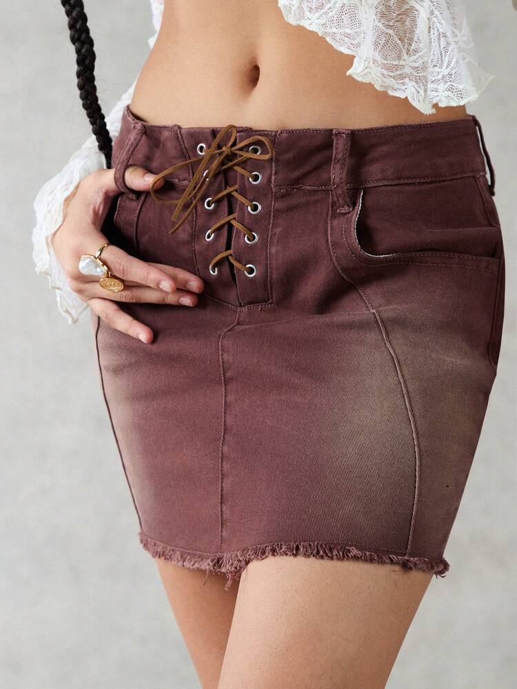 Solid Color Denim Skirt With Crisscross Belt, Diagonal Pockets And Fringed Hem