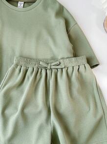 SHEIN LMoss Kids Conjunto de camiseta de cuello redondo de manga corta y pantalones cortos de unicolor tejidos para niña preadolescente para festival de música