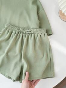 SHEIN LMoss Kids Conjunto de camiseta de cuello redondo de manga corta y pantalones cortos de unicolor tejidos para niña preadolescente para festival de música