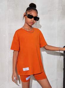 SHEIN Leap Crew Tween Girl Dệt Kim Màu Trơn Cổ Tròn Thư Giãn Áo Phông Có Chữ Cái Logo Phù Hợp Với Dệt Kim Thư Giãn Bộ Quần Short - trái cam - Xem 4