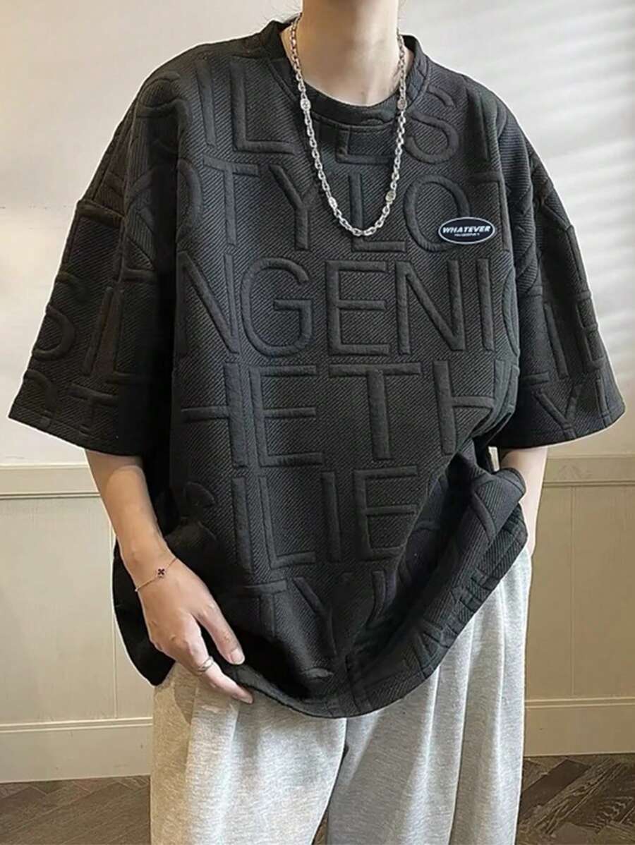 Claim Dot 男士寬鬆下垂短袖t卹,帶有字母徽章 - 黑色 - 查看 1