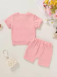 2 piezas Camiseta de niña bebé con gráfico de letras y lemas, suave y cómoda, y shorts deportivos de unicolor, conjunto casual de verano para vacaciones - Rosa - Ver 2