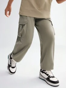 SHEIN Tween Boy Solid Color Woven Pants With Zipper Pockets, Printed Pattern And Elastic Cuffs