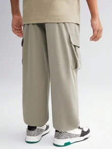 SHEIN Tween Boy Solid Color Woven Pants With Zipper Pockets, Printed Pattern And Elastic Cuffs