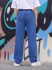 Jeans casuales y frescos para adolescentes, de tiro bajo, corte cónico y grandes, lavado azul medio con eslogan de estilo callejero y estampado de estrellas