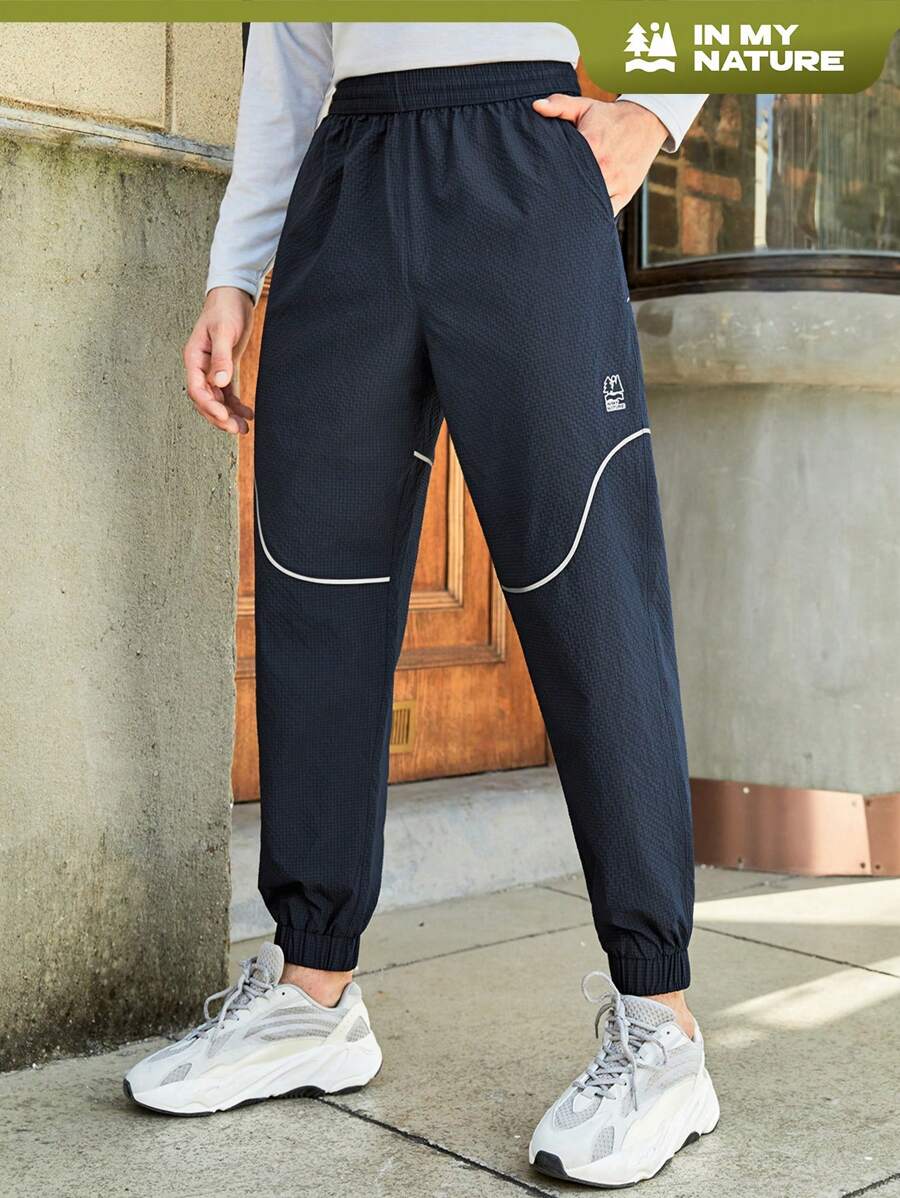 In My Nature 男士字母圖案拼接滾邊斜口袋戶外長褲