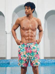 Manfinity 1 pieza Pantalón corto de verano de hombre con estampado de hojas sueltas, traje de baño a juego para parejas, vacaciones estilo hawaiano