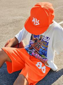 SHEIN Leap Crew Conjunto de traje de dos piezas para niño preadolescente con tema de baloncesto, con camiseta de manga corta estampada y shorts tejidos con números impresos - Naranja - Ver 2