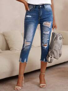 Pantalones capri de mezclilla rasgados ajustados para damas