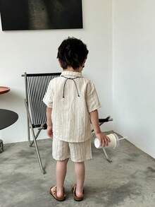 SHEIN This 2-Piece Set Of Textured Woven Shirt And Shorts For Young Boys Is A Combination Of Quality And Fashion. The Shirt Is Made Of Textured Woven Fabric, With A Delicate Feel And Comfortable Texture. The Design Is Focused On Details And Texture Processing, Displaying A Unique Fashion Style. The Shorts Are Made Of Comfortable Fabric, With A Simple And Casual Design, Suitable For Boys To Wear. The Whole Set Has A Unified Style, With Coordinated Color Matching, Displaying An Overall Sense Of Matching. This Combination Is Suitable For Both Formal Occasions And Casual Wear, Meeting Various Dressing Needs Of Boys In Daily Life. The Textured Woven Shirt And Shorts Set Not Only Has A Sense Of Fashion And Comfort, But Also Shows Delicacy And High Quality. It Is An Essential Fashion Item In The Wardrobe Of Boys, Allowing Children To Show Confidence And Taste While Wearing It. - Apricot - View 2