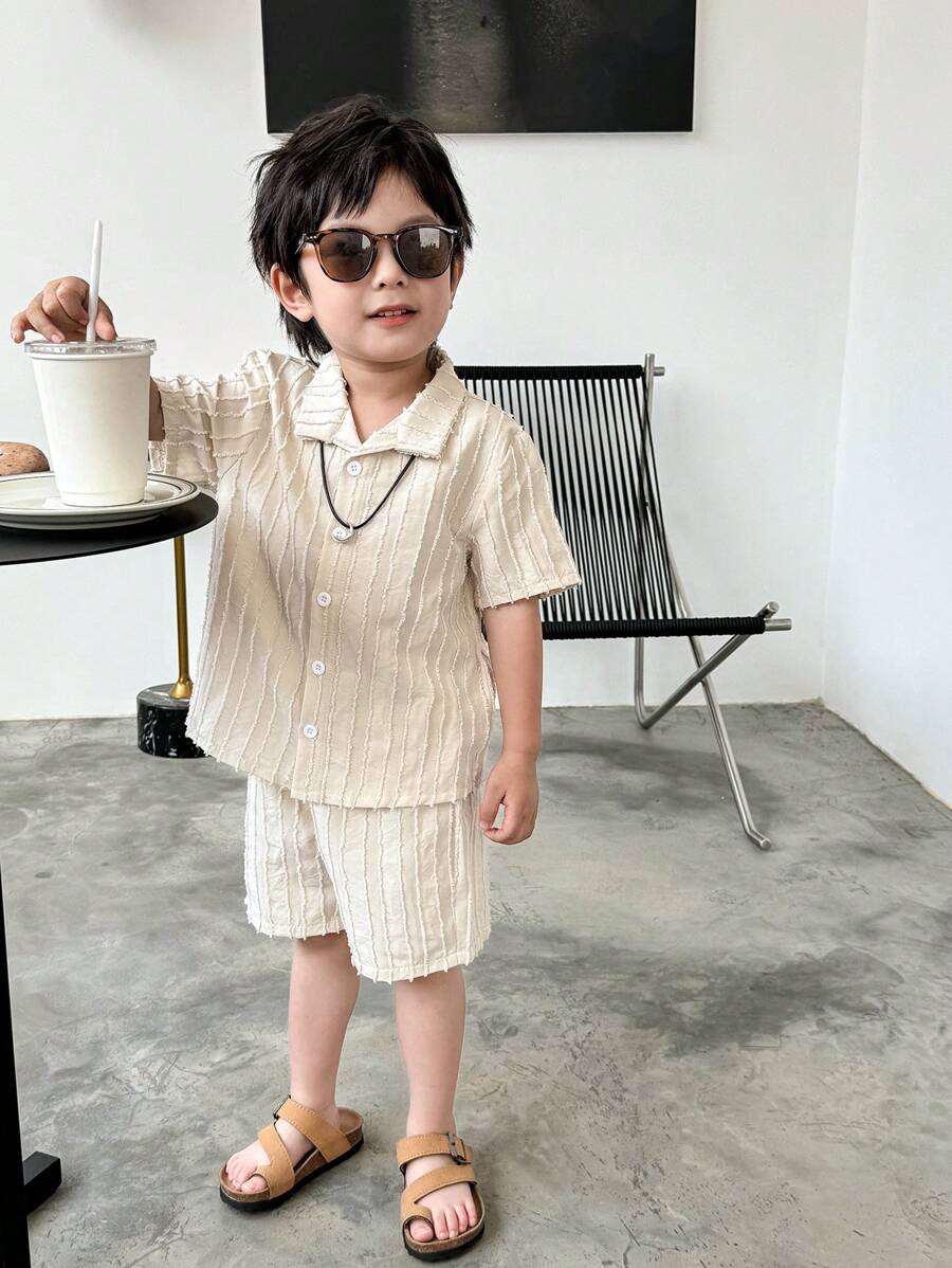 SHEIN This 2-Piece Set Of Textured Woven Shirt And Shorts For Young Boys Is A Combination Of Quality And Fashion. The Shirt Is Made Of Textured Woven Fabric, With A Delicate Feel And Comfortable Texture. The Design Is Focused On Details And Texture Processing, Displaying A Unique Fashion Style. The Shorts Are Made Of Comfortable Fabric, With A Simple And Casual Design, Suitable For Boys To Wear. The Whole Set Has A Unified Style, With Coordinated Color Matching, Displaying An Overall Sense Of Matching. This Combination Is Suitable For Both Formal Occasions And Casual Wear, Meeting Various Dressing Needs Of Boys In Daily Life. The Textured Woven Shirt And Shorts Set Not Only Has A Sense Of Fashion And Comfort, But Also Shows Delicacy And High Quality. It Is An Essential Fashion Item In The Wardrobe Of Boys, Allowing Children To Show Confidence And Taste While Wearing It. - Apricot - View 1