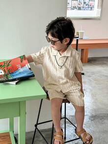 SHEIN This 2-Piece Set Of Textured Woven Shirt And Shorts For Young Boys Is A Combination Of Quality And Fashion. The Shirt Is Made Of Textured Woven Fabric, With A Delicate Feel And Comfortable Texture. The Design Is Focused On Details And Texture Processing, Displaying A Unique Fashion Style. The Shorts Are Made Of Comfortable Fabric, With A Simple And Casual Design, Suitable For Boys To Wear. The Whole Set Has A Unified Style, With Coordinated Color Matching, Displaying An Overall Sense Of Matching. This Combination Is Suitable For Both Formal Occasions And Casual Wear, Meeting Various Dressing Needs Of Boys In Daily Life. The Textured Woven Shirt And Shorts Set Not Only Has A Sense Of Fashion And Comfort, But Also Shows Delicacy And High Quality. It Is An Essential Fashion Item In The Wardrobe Of Boys, Allowing Children To Show Confidence And Taste While Wearing It. - Apricot - View 4