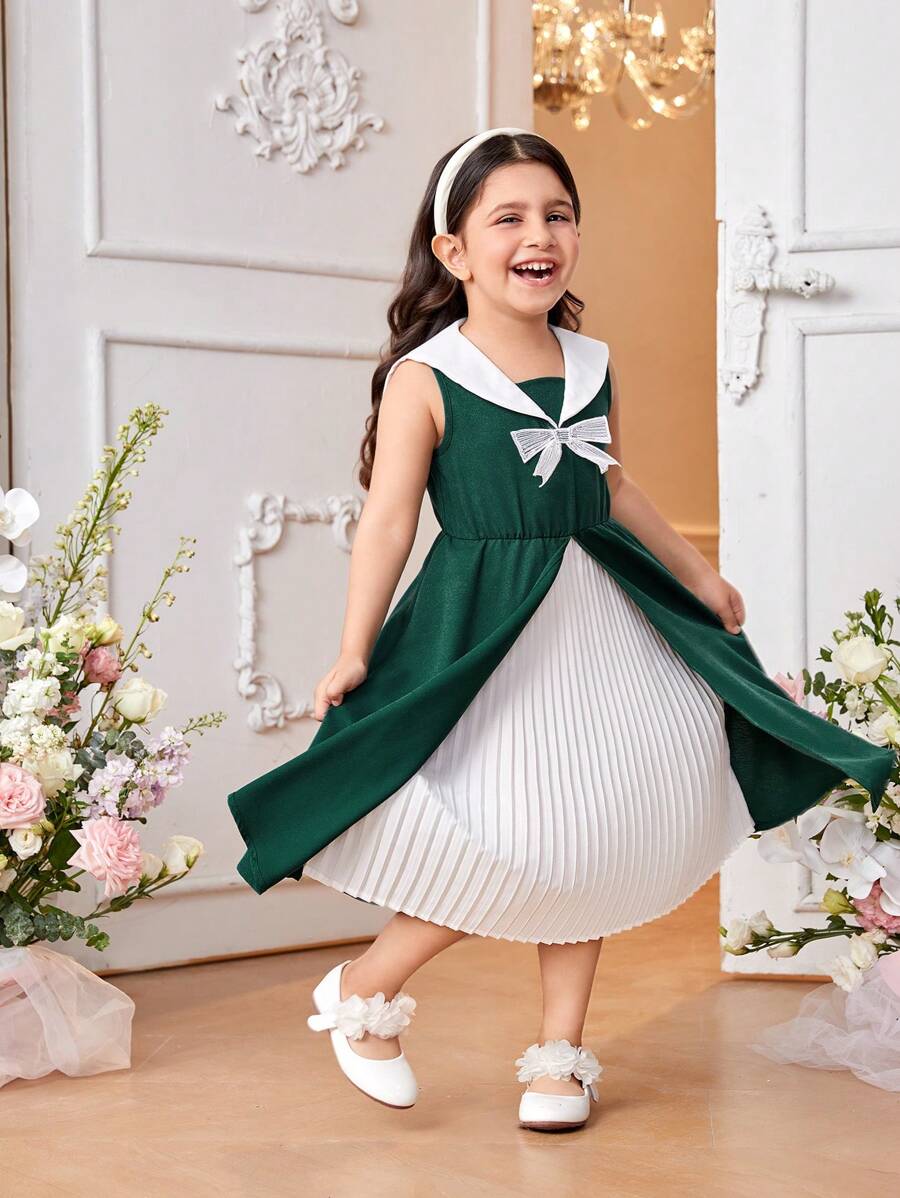 SHEIN Holiday,Summer,Travel  Young Girl Green Sleeveless Patchwork Dress . The Dress Is Mainly In Fresh Green, Showing A Natural And Energetic Atmosphere. There Is An Exquisite Bow On The Chest, Which Makes The Dress More Playful And Cute. The Patchwork Part Of The Skirt Is Made Of White Textured Fabric, Which Makes The Dress More Layered And Three-Dimensional. It Is Suitable For Daily Leisure, Outdoor Travel, Outdoor Activities, And Suitable For Spring And Summer Seasons. - Dark Green - View 1