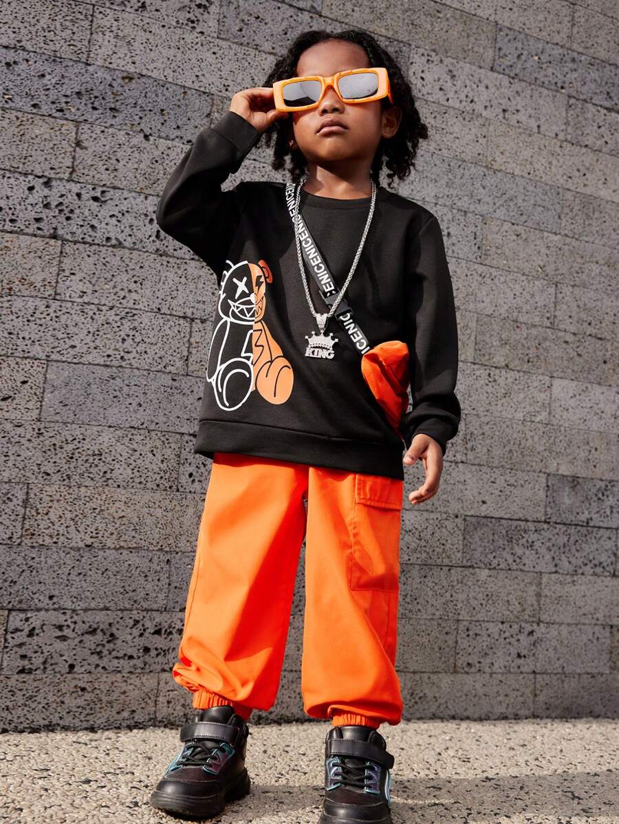 SHEIN Explorewe Áo nỉ in hình chú gấu hoạt hình ngộ nghĩnh và dễ thương dành cho bé trai, Quần có túi phong cách công sở màu cam, Dây treo chữ và trang phục túi đeo vai màu cam, Thích hợp cho mùa thu đông, thích hợp cho nhiều dịp khác nhau, đẹp trai và thoải mái - Nhiều màu - Xem 1