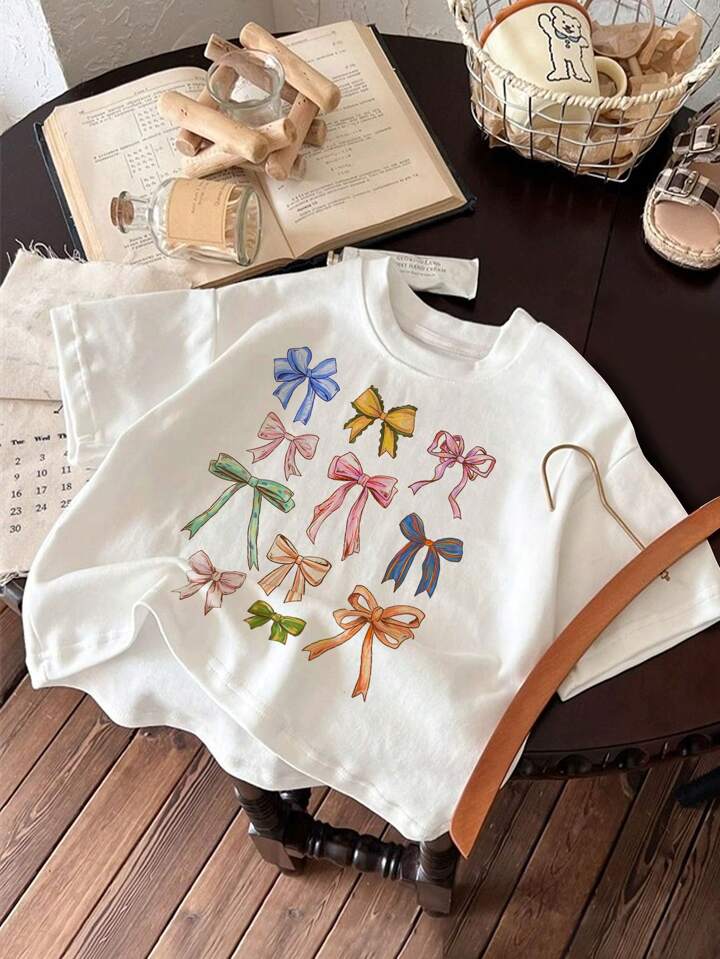 SHEIN Cute Tops Tween Girls Casual Minimalist Hand Drawn Bow Tie Printed Short Sleeve Round Neck T Shirt Suitable For Spring Summer