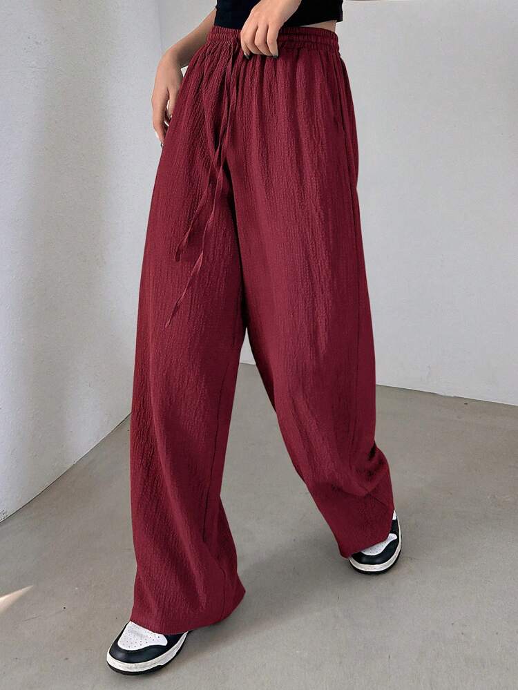 Pantalon long et ample unicolore texturé décontracté avec taille élastique et cordon de serrage pour femmes