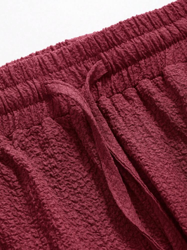 Pantalon long et ample unicolore texturé décontracté avec taille élastique et cordon de serrage pour femmes