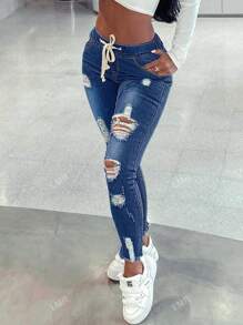 Pantalones ajustados desgastados con dobladillo crudo y cintura ajustable con cordón