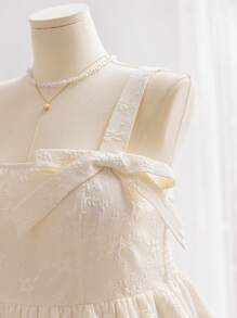 Soleia 大码女式度假象牙色纹理宽肩带蝴蝶结装饰荷叶边分层下摆吊带背心 - 杏色 - 查看 4
